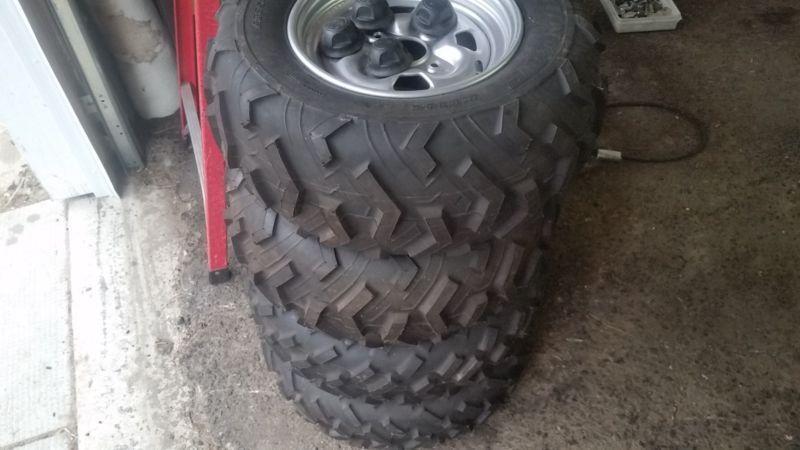4 BRAND NEW NEVER DRIVING ON YAMAHA GRIZZLY TIRES AND RIMS