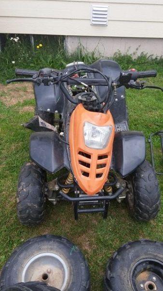 gio atv at with alot of parts